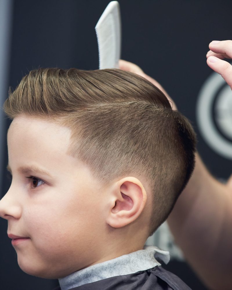 Barber,Shop.,Barber,Makes,Hairstyle,To,A,Boy,With,Styling